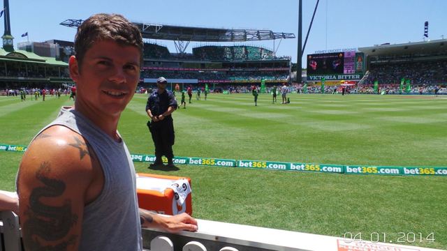 A man taking a selfie beside the pitch at the Sydney Cricket Ground.
