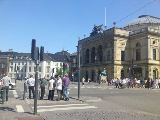 A grand theatre building on a busy Copenhagen square.