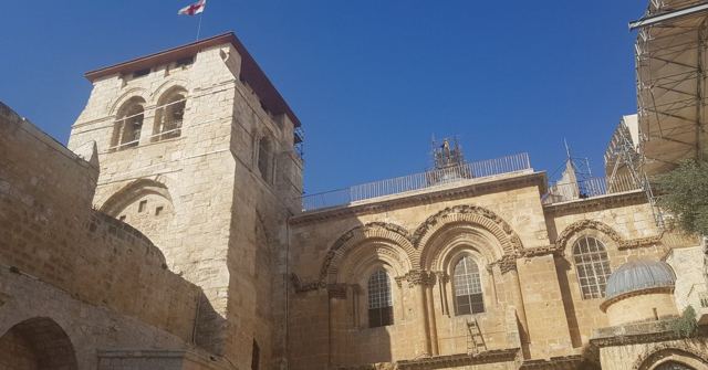 The stone facade and bell tower of the Church of the Holy Sepulchre in Jerusalem.