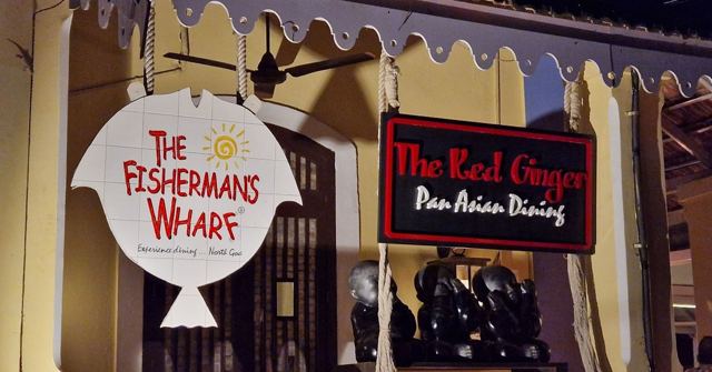 Restaurant signs reading The Fisherman's Wharf and The Red Ginger outside a covered dining area.