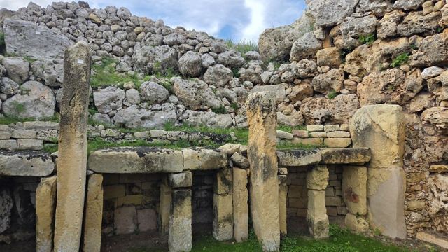 Close view of a prehistoric temple doorway made of upright limestone megaliths and huge stacked stones.