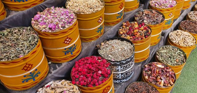 Tubs of dried flowers and spices in a Marrakech souk.