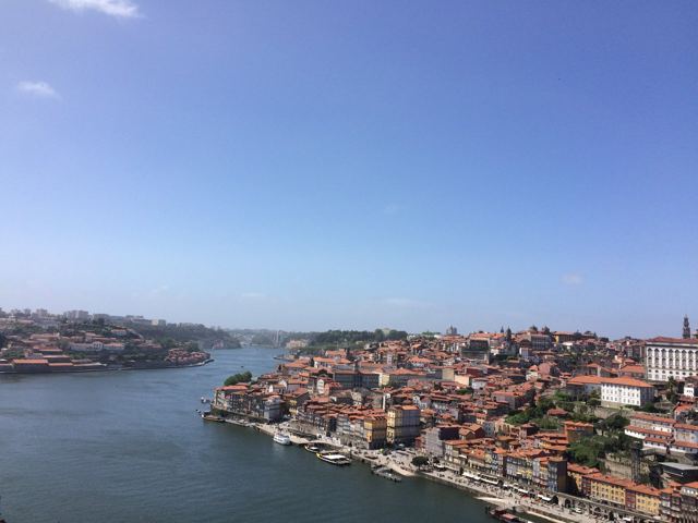 Porto's riverside old town tumbling down to the Douro under a blue sky