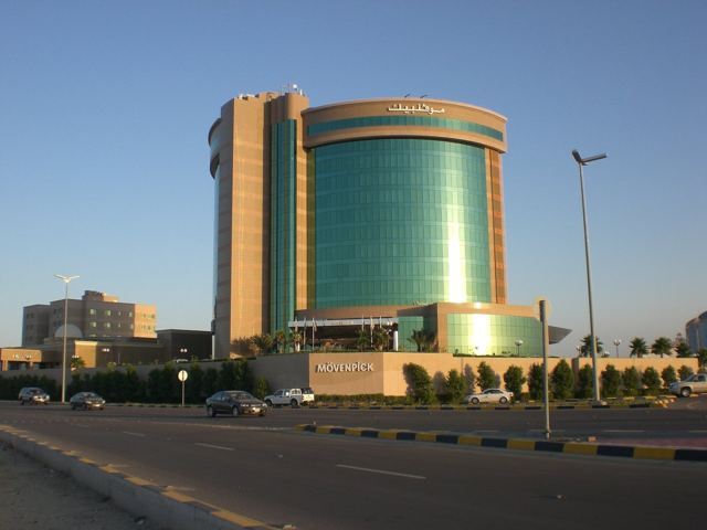 A mirrored glass tower in Al Khobar catching the late afternoon light.