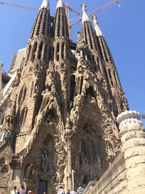 The towering spires of Gaudí's Sagrada Família against a deep blue sky