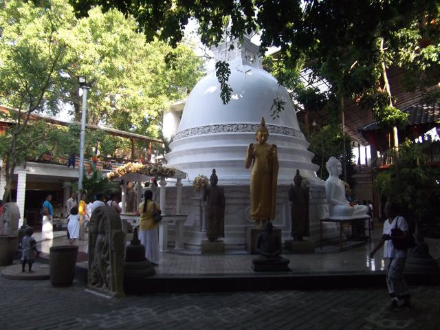 A white stupa and temple buildings in Colombo.