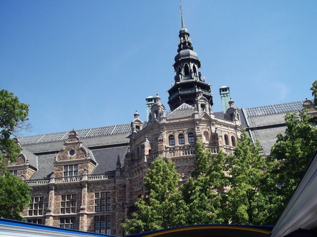 A grand turreted building in Stockholm under a blue sky.