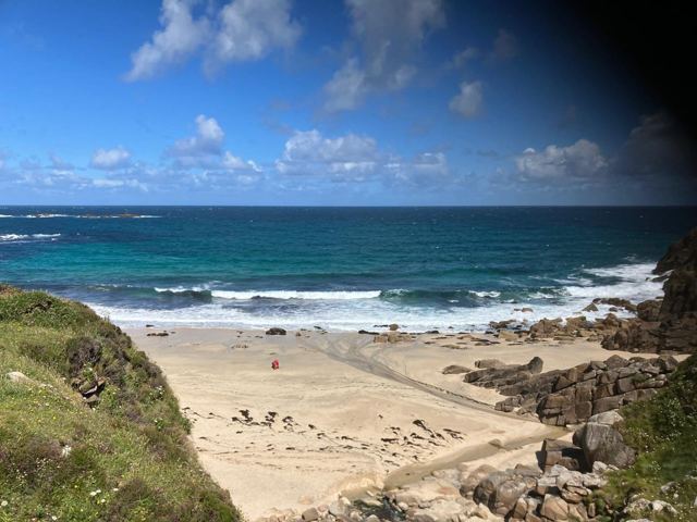 A golden beach and turquoise sea on the Cornish coast.