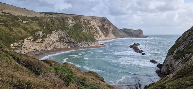 Waves rolling into the white chalk cliffs of the Jurassic Coast near Durdle Door