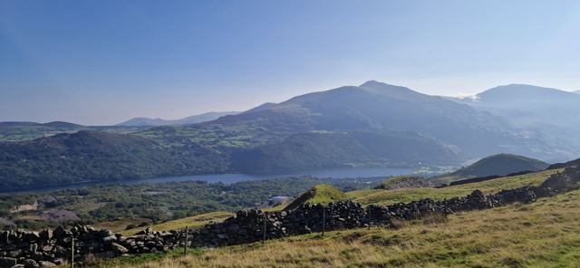 The mountains of Snowdonia under a blue sky.